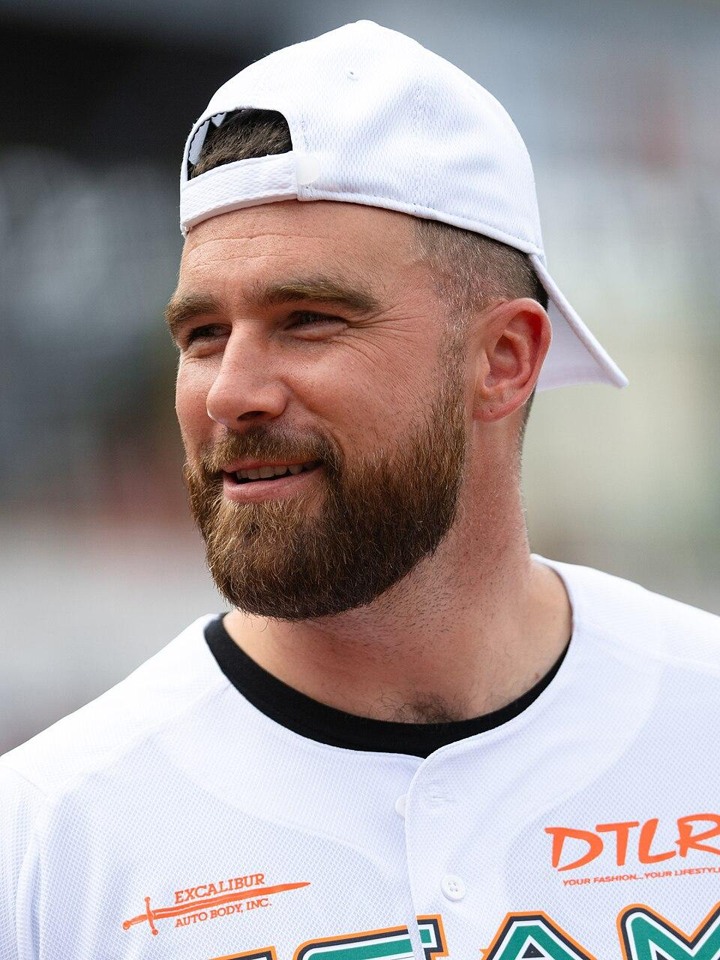 Travis Kelce wearing a cap and softball jersey in a separately taken June 2024 photograph.